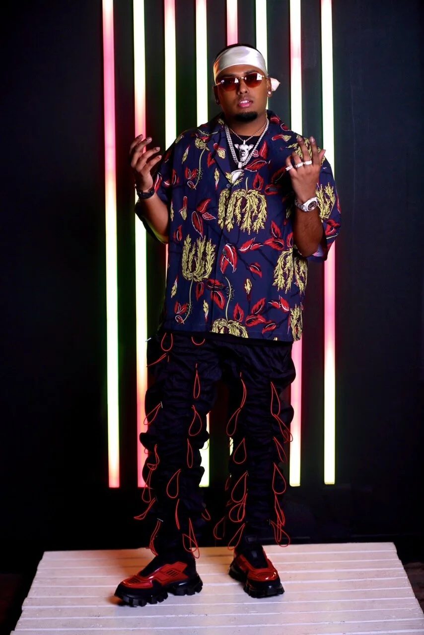 DJ SpinKing against neon light columns